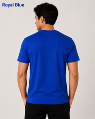 Man wearing a blue t-shirt on a plain background